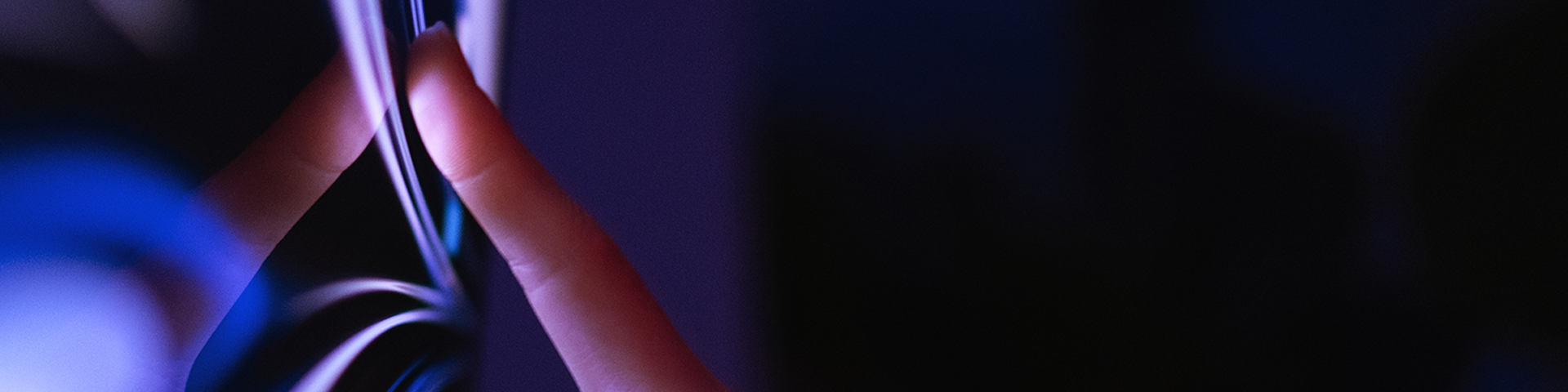 A close-up of the interaction between persons hand and a large touch screen display.