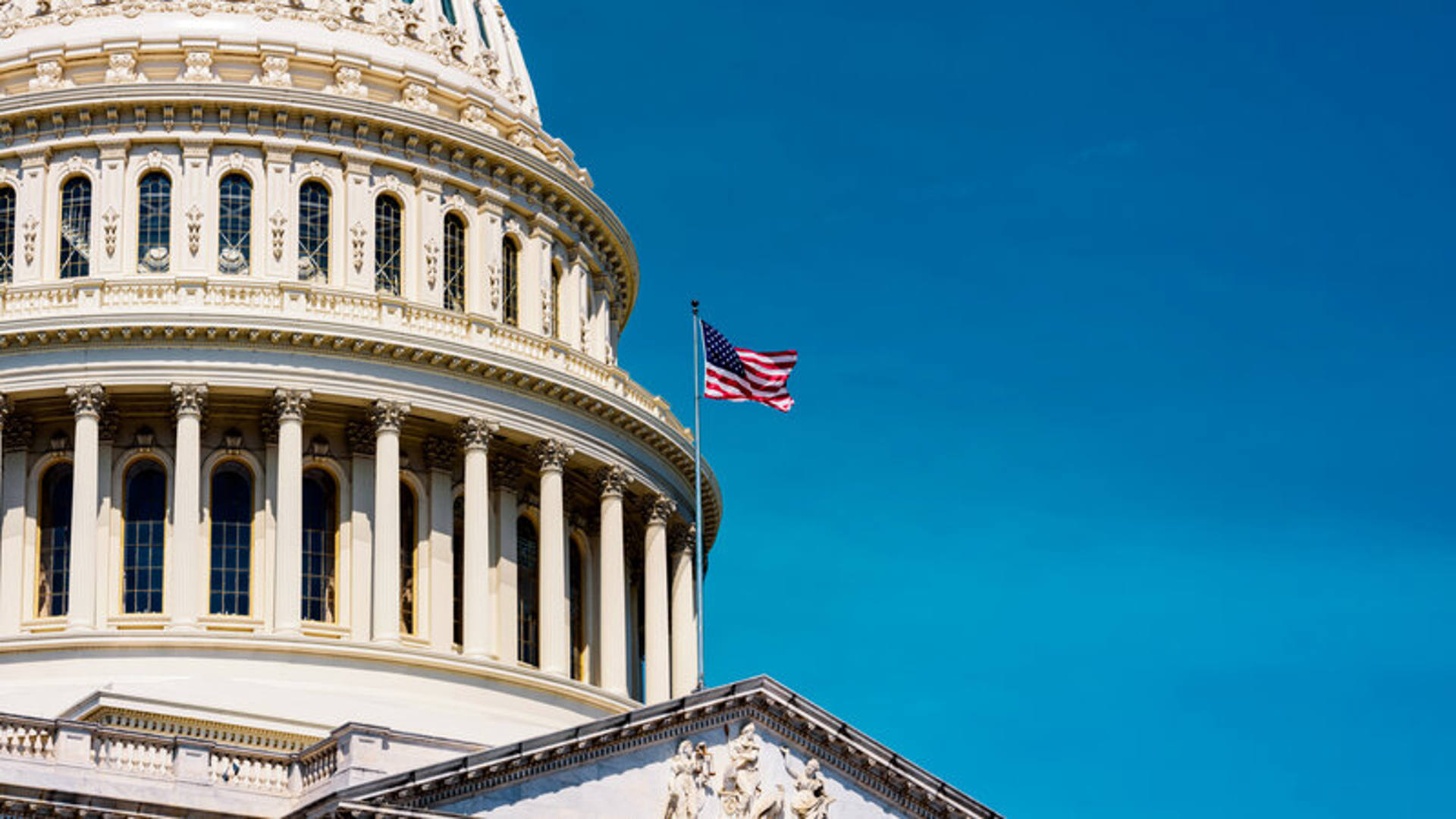 Close-up image of the U.S. Capitol building, emphasizing its majestic dome and classic design elements.