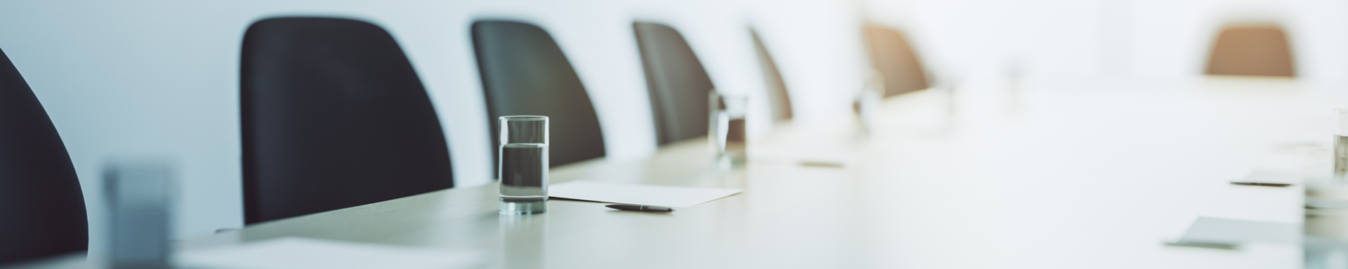 A well-arranged conference table with chairs and glasses of water, set for discussions and collaboration.