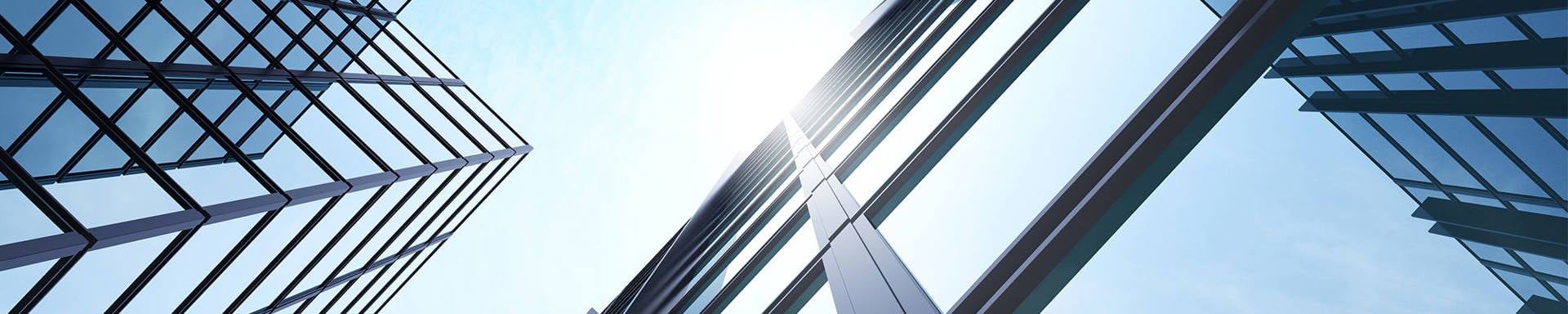 A skyline featuring tall buildings adorned with numerous windows reflecting the surrounding environment.